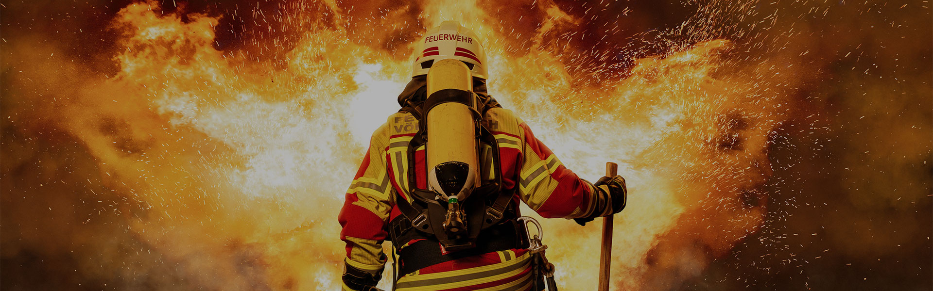 firefighter in front of flames and sparks